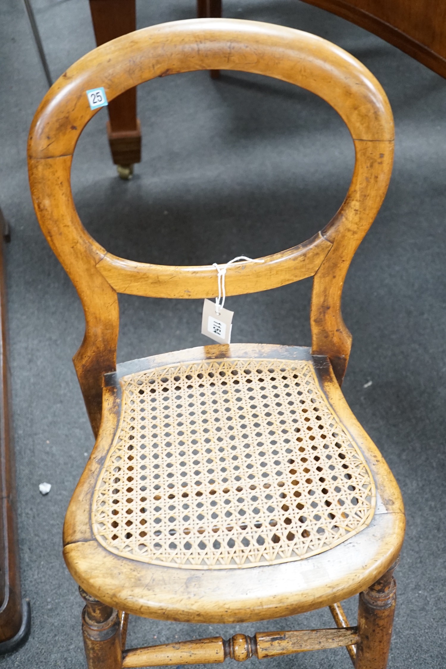 A Victorian caned beech child's correction chair and an Edwardian inlaid mahogany oval occasional table